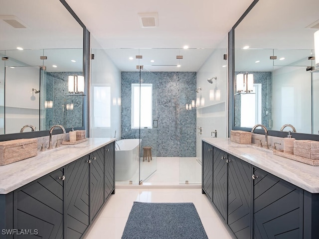 bathroom with independent shower and bath, vanity, and tile patterned floors