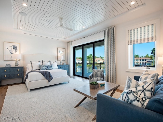 bedroom featuring hardwood / wood-style flooring, access to exterior, and wood ceiling