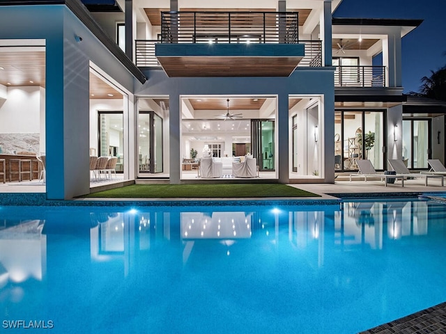 back of house with a balcony, ceiling fan, and a patio area