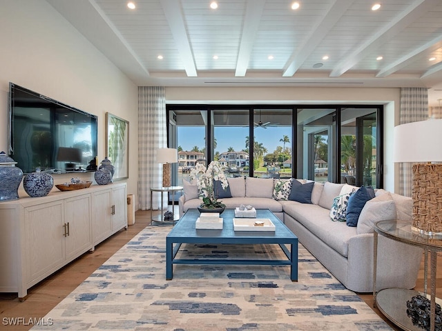 living room with beamed ceiling and light hardwood / wood-style flooring