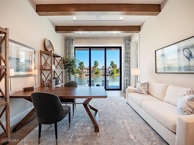 office area featuring wood-type flooring, a water view, and beam ceiling