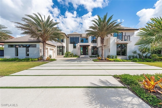 view of front of property with a front yard and a balcony