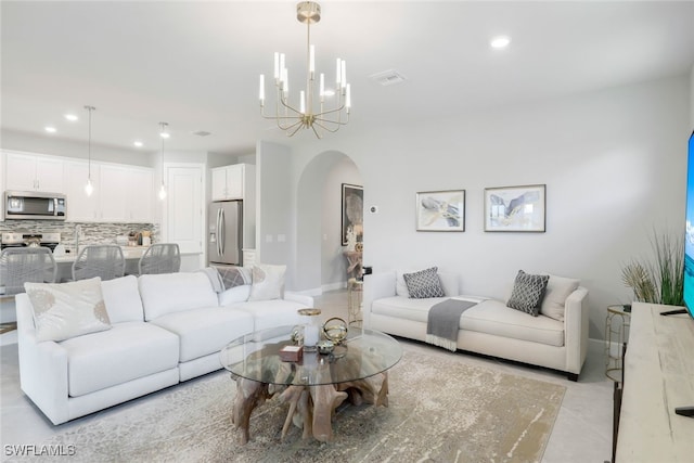 living room with light tile patterned floors and an inviting chandelier