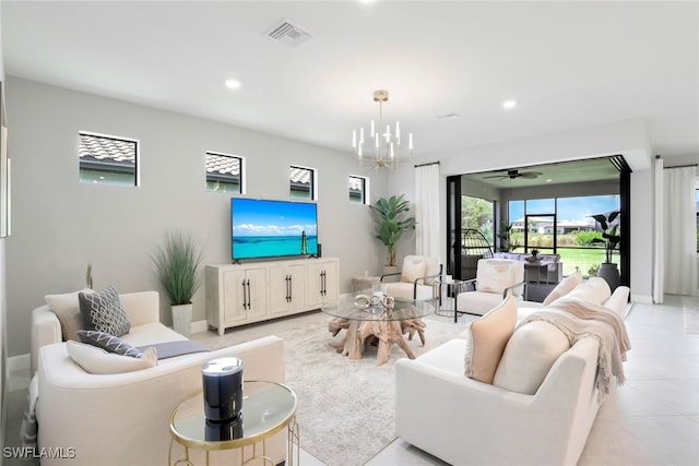 tiled living room featuring ceiling fan with notable chandelier