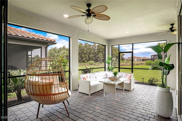 sunroom featuring ceiling fan