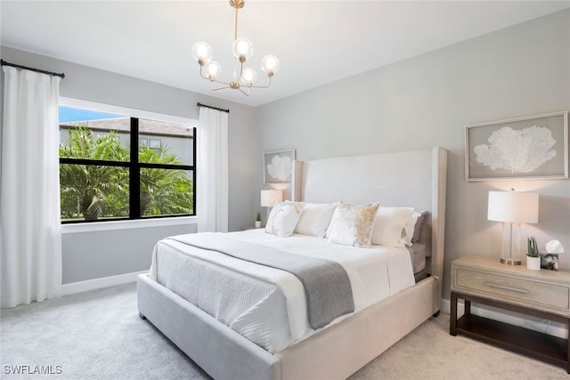 carpeted bedroom featuring a chandelier