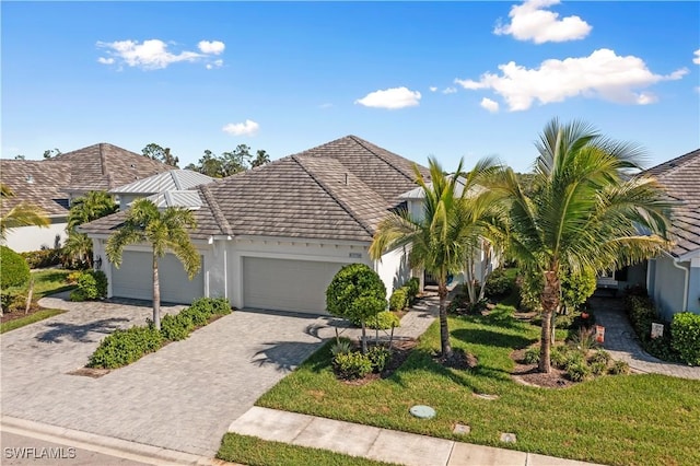 view of front of home with a front yard and a garage