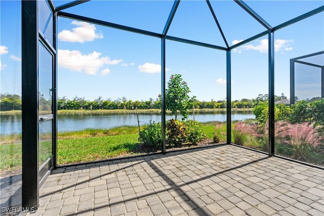 unfurnished sunroom featuring a water view