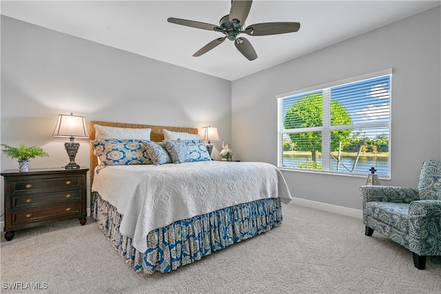 bedroom featuring ceiling fan and light colored carpet