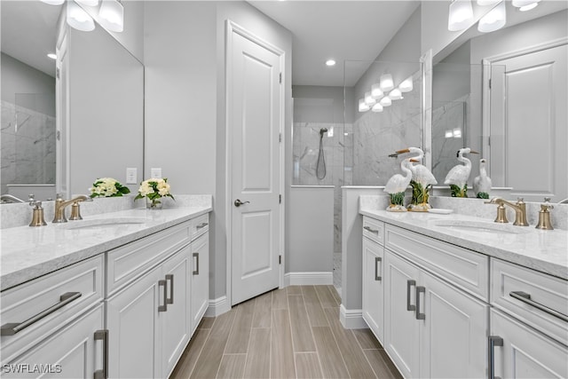 bathroom with vanity and a tile shower