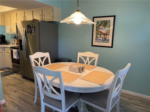 dining area featuring dark hardwood / wood-style flooring