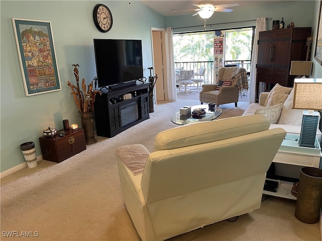 living room with lofted ceiling, ceiling fan, and carpet