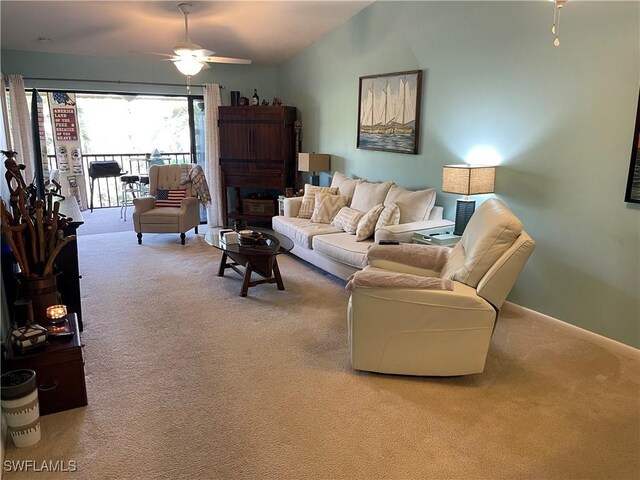 living room with ceiling fan, lofted ceiling, and carpet floors