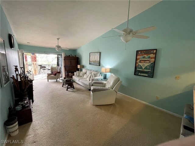 carpeted living room featuring vaulted ceiling and ceiling fan