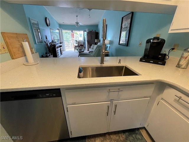 kitchen with dishwasher, sink, white cabinets, light stone counters, and ceiling fan