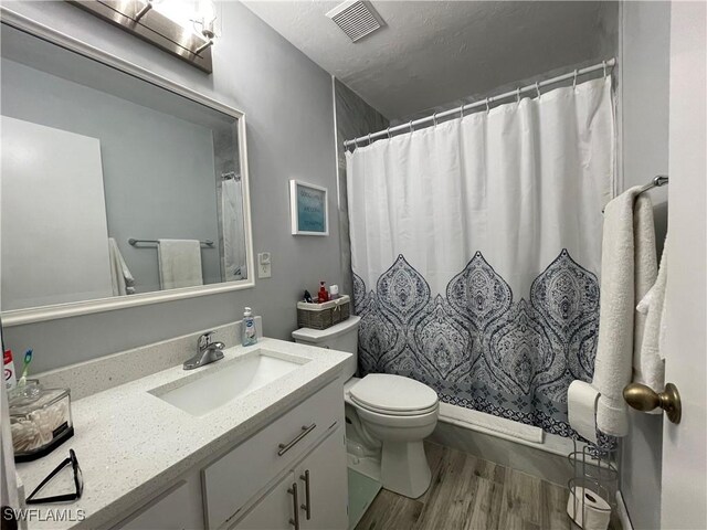 bathroom with vanity, hardwood / wood-style floors, toilet, and a shower with shower curtain