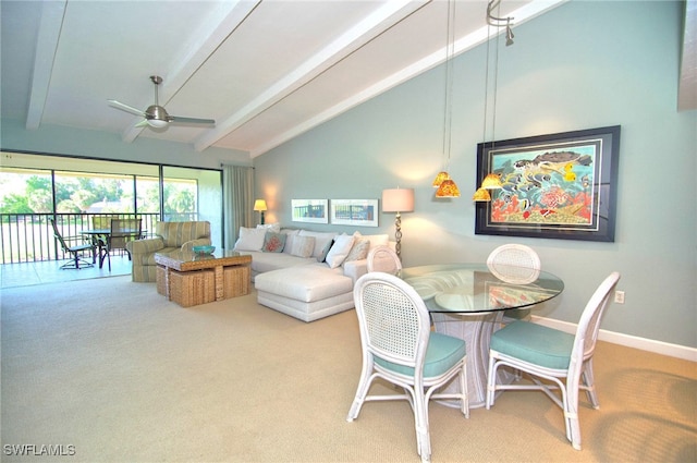 carpeted dining space with beam ceiling, high vaulted ceiling, and ceiling fan