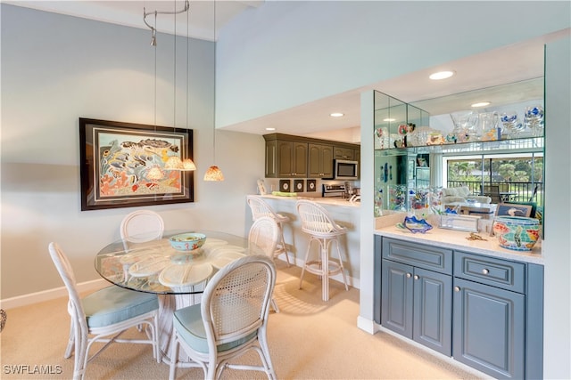 carpeted dining room featuring a high ceiling