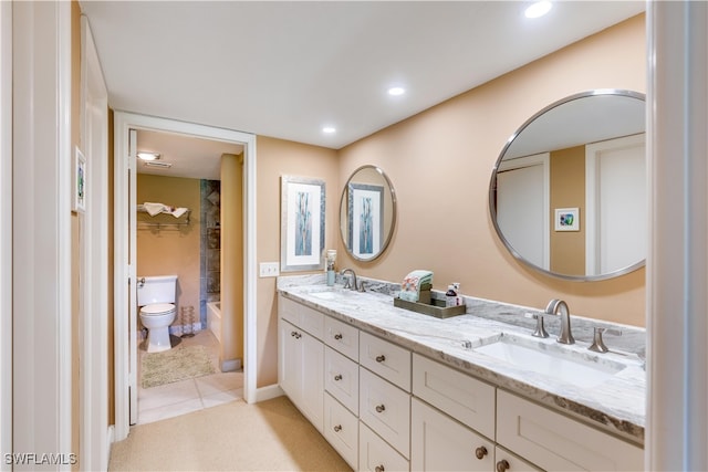 bathroom featuring toilet, vanity, and tile patterned flooring