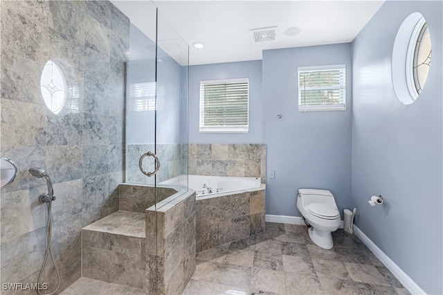 bathroom with toilet and shower with separate bathtub