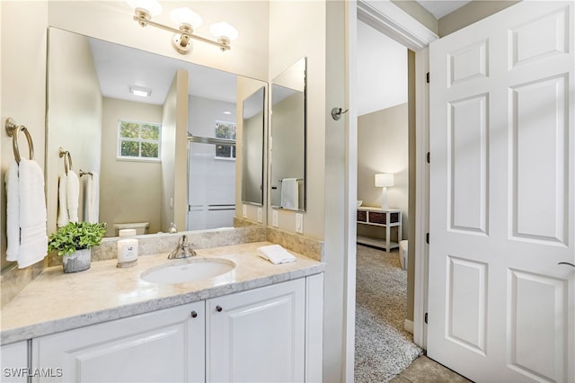 bathroom featuring tile patterned flooring, vanity, and toilet