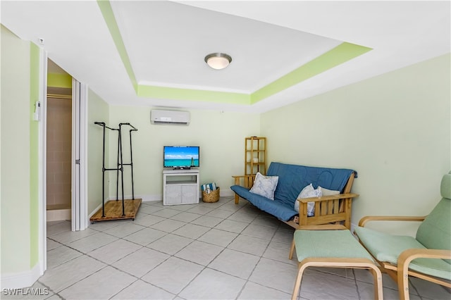 sitting room with light tile patterned flooring, a tray ceiling, and a wall mounted AC