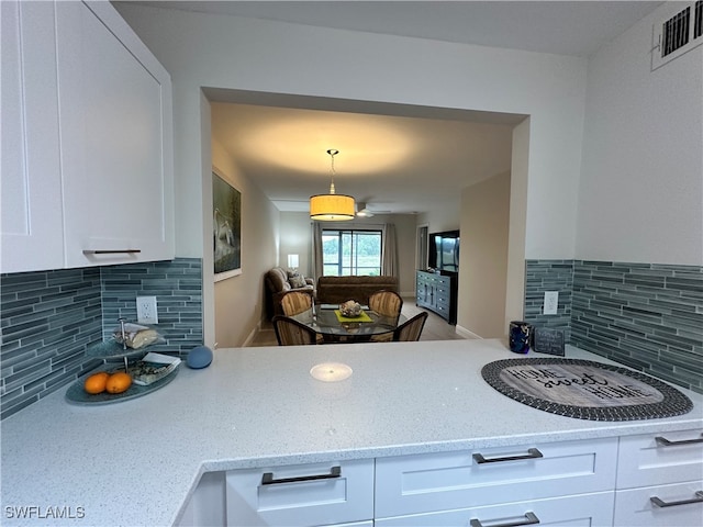 kitchen featuring white cabinetry and tasteful backsplash