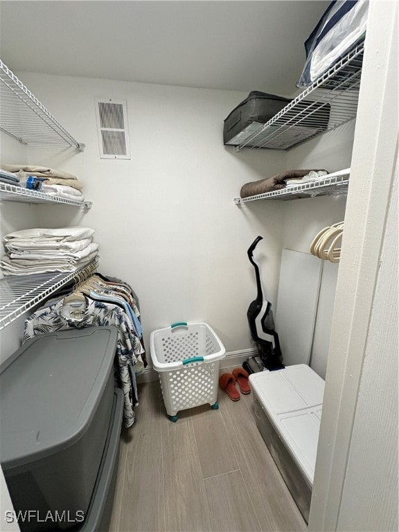 spacious closet featuring hardwood / wood-style flooring