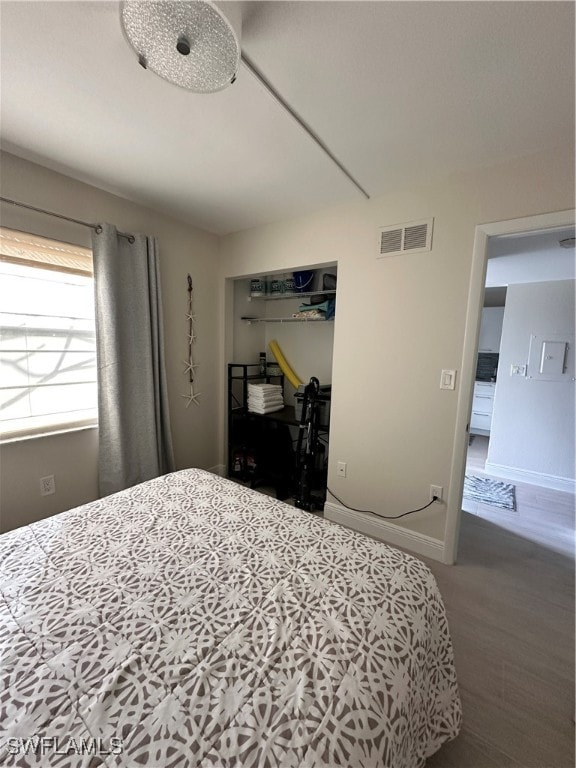 bedroom with hardwood / wood-style floors