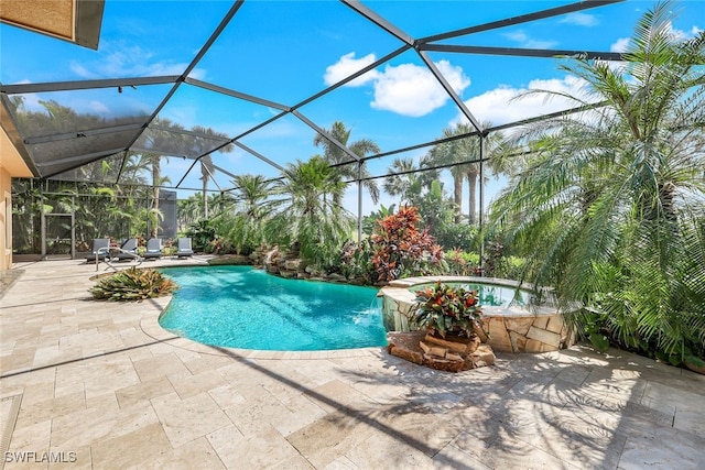 view of swimming pool with an in ground hot tub, a patio area, pool water feature, and glass enclosure