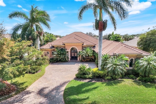 mediterranean / spanish house with a front yard