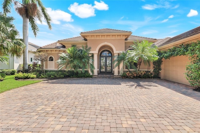 mediterranean / spanish-style house with french doors and a garage