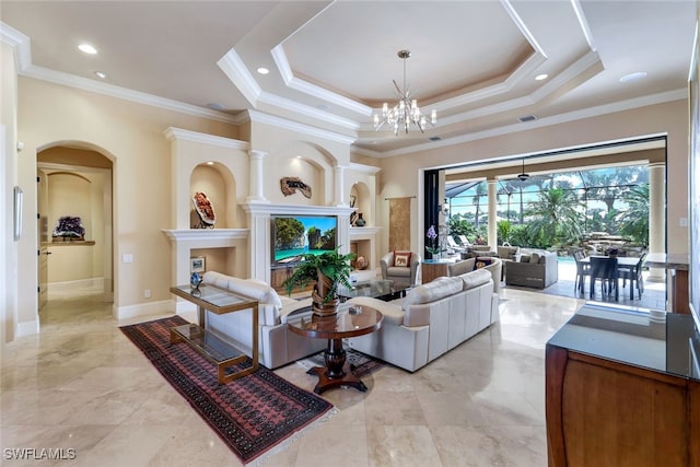 living room featuring crown molding, a tray ceiling, and an inviting chandelier