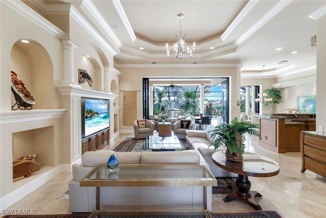 living room with crown molding, a chandelier, and a tray ceiling