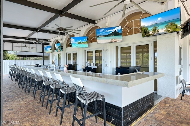 view of patio / terrace featuring french doors, exterior bar, and ceiling fan