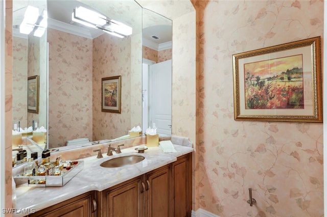 bathroom featuring vanity, ornamental molding, and toilet