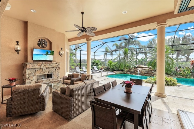 view of patio / terrace with an outdoor hangout area, glass enclosure, and ceiling fan