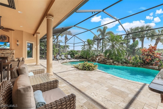 view of swimming pool with a patio area, a lanai, and ceiling fan