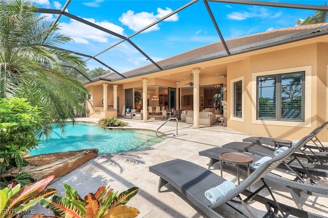 view of pool featuring a patio, ceiling fan, and glass enclosure