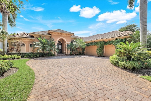 mediterranean / spanish house featuring a garage