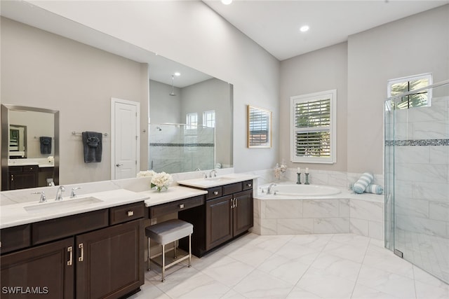 bathroom featuring vanity and independent shower and bath