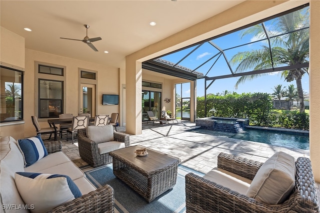 view of patio with a pool with hot tub, ceiling fan, a lanai, and an outdoor hangout area