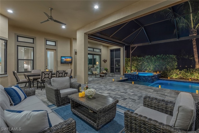 view of patio with ceiling fan, outdoor lounge area, and an in ground hot tub