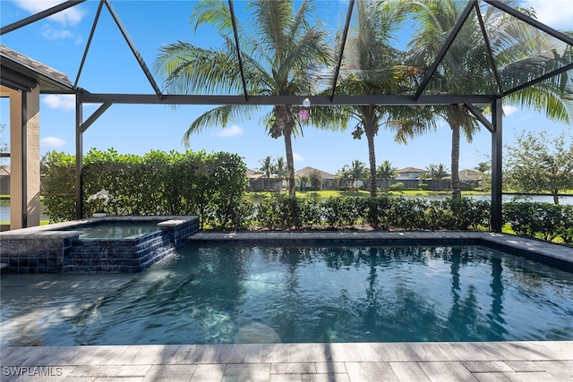 view of pool with glass enclosure and an in ground hot tub