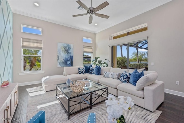 living area with dark wood-style flooring, crown molding, baseboards, and ceiling fan