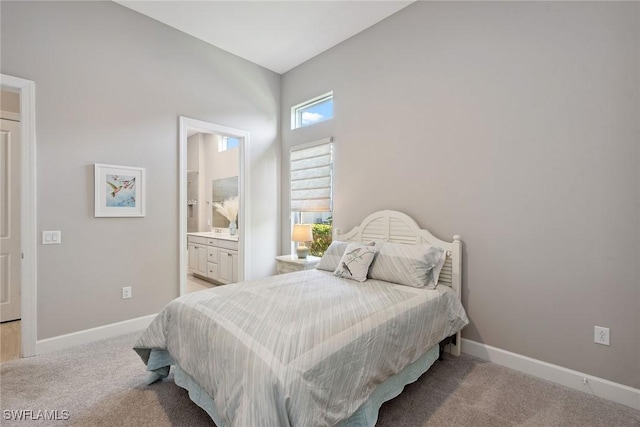 bedroom featuring connected bathroom, baseboards, and carpet flooring