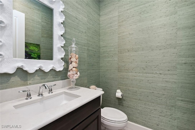 bathroom with toilet and vanity