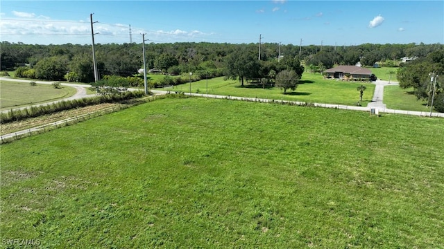 surrounding community with a forest view, a yard, and a rural view