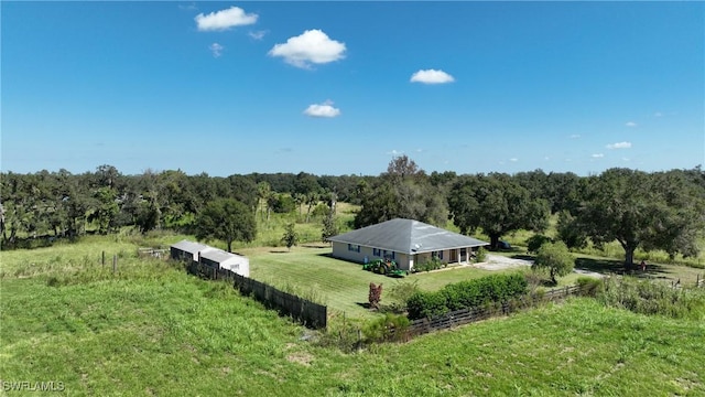 birds eye view of property featuring a wooded view