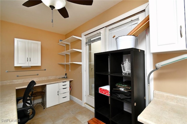 office with a ceiling fan, baseboards, and light tile patterned floors